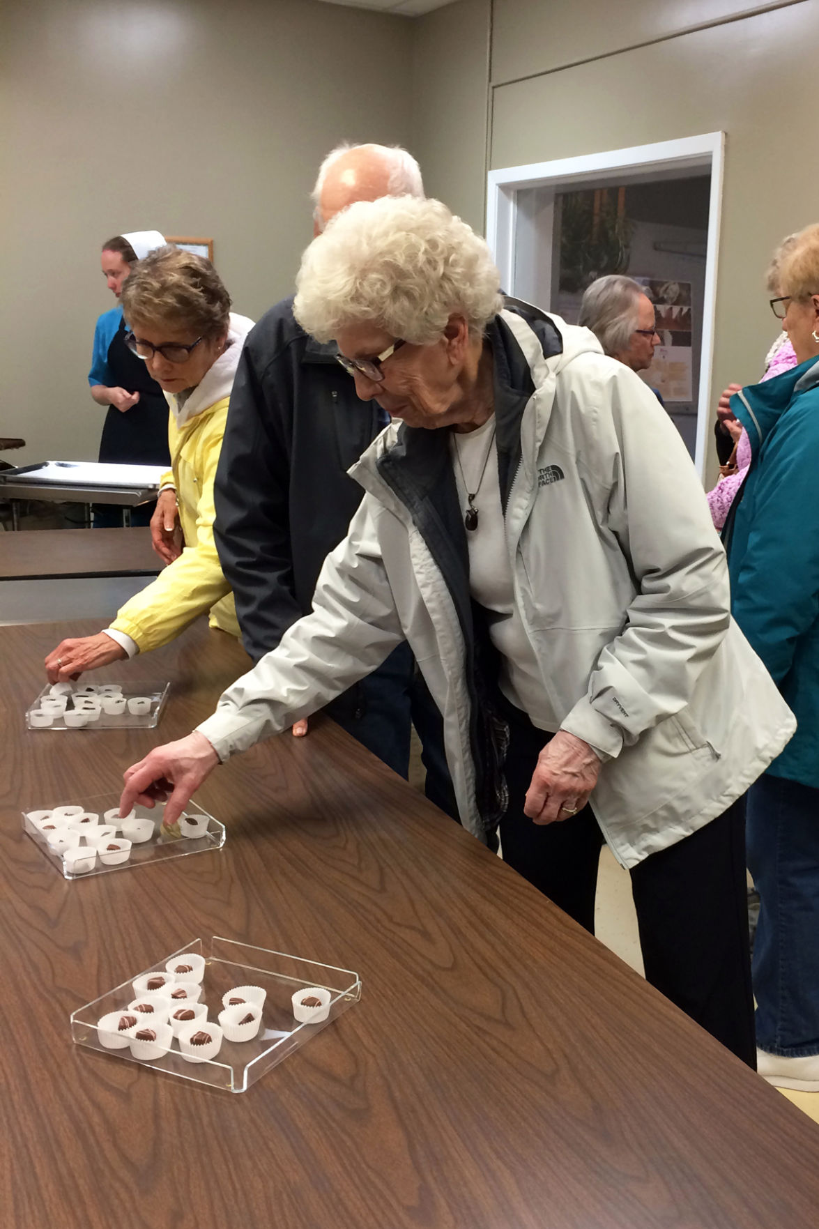 068 Darlene Janzen samples the goodies at Kalona Chocolates.JPG